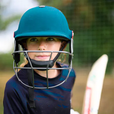 Girls_Cricket Young girl in cricket gear in the nets facing up