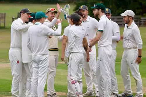 mens_celebrating North London Cricket senior mens players celebrating a wicket in a huddle